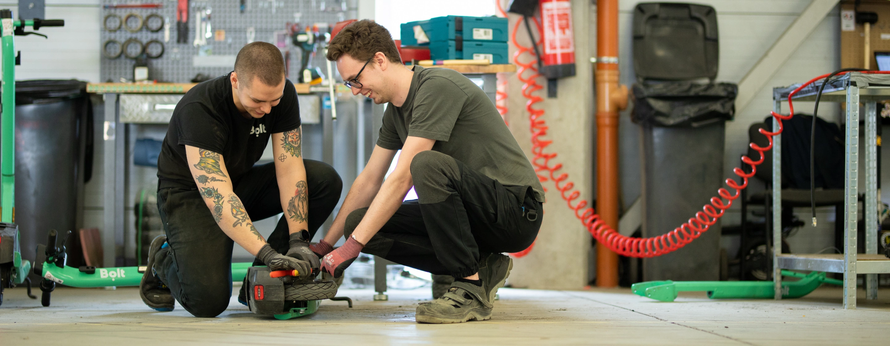 Bolt warehouse workers in a warehouse with scooters